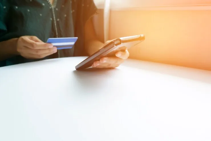 holding-smart-phone-credit-card
